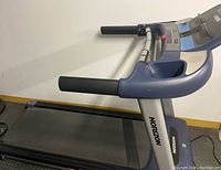 Side view of treadmill showing the walking belt, handrails, and Horizon branding on frame.