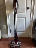 Full view of upright corded stick vacuum showing handle, black power cord, and base with Duo Clean label.