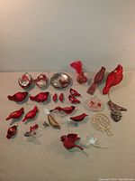 Photo of 24 assorted bird and cardinal ornaments made of glass, plastic, and wood. Various red, clear, and glittered finishes.