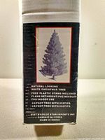 Photo of original box showing image of white Christmas tree and product details