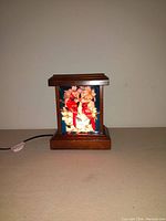 Front view of the handpainted cardinal light with wooden frame and stained glass showing bright red cardinals on flowers and branches.