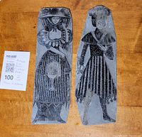 Photo showing both metal printing plates side by side on wooden surface