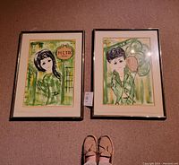 Two framed mixed media artworks by Francois Paris hanging on a carpeted floor, showing full view with reflections on glass and a visible measuring tag.