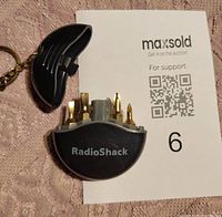 Open RadioShack keychain mini screwdriver set showing gold-colored bits inside