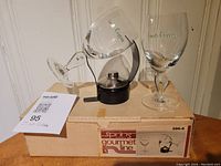 Photo showing two Irish Coffee glasses with green shamrock on stems and a metal burner on original box.