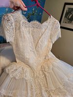 Close-up of upper bodice showcasing lace fabric and short sleeves