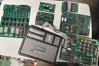 Overview photo showing multiple HVAC circuit boards and the Liebert System 1 control panel on a white surface.