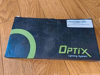 Box packaging showing Optix branding and model details.