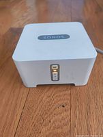 Top front view showing Sonos logo, control buttons with illumination.