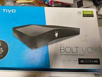 Closed box of TiVo Bolt Vox showing branding, storage capacity (500GB), and 4K Ultra HD features.