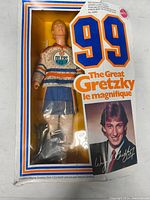 Front view of Wayne Gretzky figure in box showing figure in Oilers jersey and number 99 on front