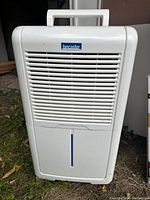 Front view showing Lancaster brand portable electric cooler with air vent grill and carrying handle.