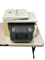 Front view of HP OfficeJet Pro printer showing touchscreen and paper trays