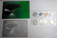 Complete set packaging with a green Royal Canadian Mint folder and informational leaflet along with the sealed coin set.