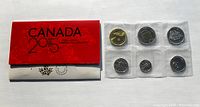 Photo of 2015 Canada coin set in original red folder and coins sealed in plastic.