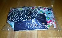 Two packed Thirty-One thermal bags, showing floral pattern through plastic packaging.