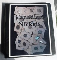 Photo of the front cover of the black coin album labeled 'Canadian Nickels' showing numerous Canadian nickel coins in 2x2 holders on the cover image.
