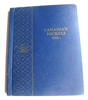 Cover of the blue coin album with gold text stating 'Canadian Nickels 1922-' and decorative vertical gold pattern.