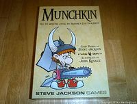 Front view of the Munchkin game box showing the title, illustrator, and designer credit.