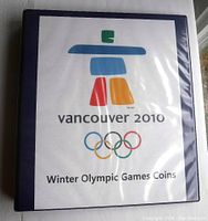 Front cover of the blue album with Vancouver 2010 logo and Olympic rings, titled 'Winter Olympic Games Coins'.