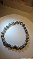 Top-down photo showing full circular stretchy bracelet with uniform round 6mm jasper beads.