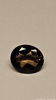 Close-up image of the oval cut smokey quartz gemstone showing facets and color.