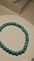 Close-up view of the natural turquoise stretchy bracelet beads showing color and matrix details