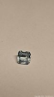 Single octagon cut natural untreated aquamarine gemstone on neutral background showing color and cut