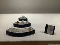 Three-tier mirrored display showing all eight figurines grouped