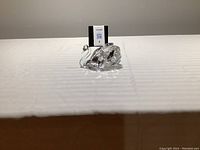 Front view of the crystal swan figurine on white surface