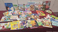 Wide view of all children's books laid out on a surface showing cover art and arrangement