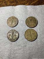 4 Canadian 1943 Victory 5 cent coins on a white surface, showing the date and central torch V design clearly.