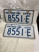 Matched pair of original 1966 Ontario license plates with registration 8551-E, showing wear and rusting.