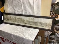 Full panoramic view of framed military group photo resting on table showing entire dimensions and frame.
