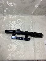 Full view of Bushnell hunting scope showing length and mounting hardware.