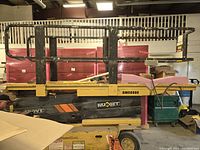 Side view of scissor lift showing platform, guard rails and base frame