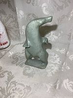 Front and side view of the standing soapstone bear figurine showing shape and stone texture