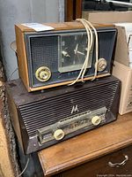 Photo of stacked vintage Viking and Motorola radios on wooden surface, showing overall condition and appearance.