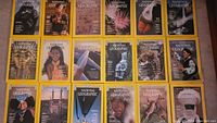 Photo of 15 National Geographic magazines in a single flat layout, showing yellow bordered covers with various images including historical, cultural, natural scenes and wildlife.