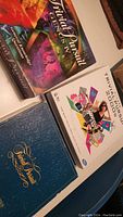 Photo showing the three different Trivial Pursuit game boxes placed on a table: Classic Edition, 2000s Edition, and Family Edition.