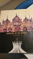 Cover of the book 'Wonders Of The World' showing a historic cathedral with domes and architectural details, with a modern design element below.