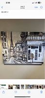 Photo of one canvas painting showing Paris streets with Eiffel Tower, neutral tones and textured detail