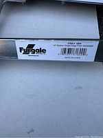 Close-up of label on one squeegee showing brand Furgale, item number 3304, 18-inch rubber single-edge floor squeegee, made in China.