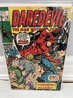 Front cover of Daredevil #70 comic book showing Daredevil in red costume amidst police and a crowd, with speech bubbles referencing a bomb blast and the Thermoil flame.