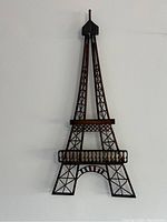 Front view of the Eiffel Tower metal art showing lattice metal structure and wooden details