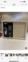 Front view of beige AMSEC safe with electronic keypad and key lock on front