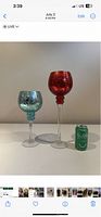 Two decorative glass vases side by side with a soda can for scale.
