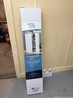 Photo of unopened storage cabinet box showing front label with product image and details.