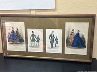 Full view of the framed set of four antique fashion engravings, showing the entire frame and arrangement.