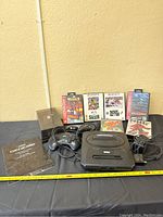 Full lot with Sega Genesis console, two controllers, six game cartridges in cases, instruction manual, and power cord.
